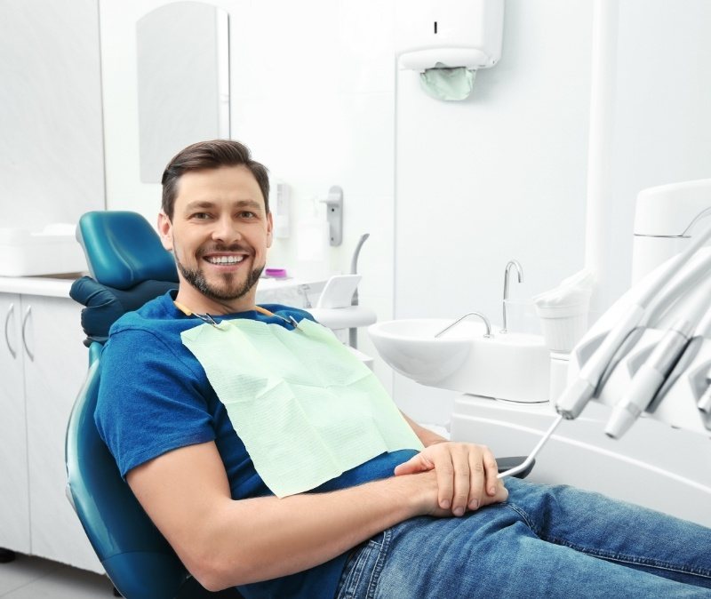 Man in dental chair smiling