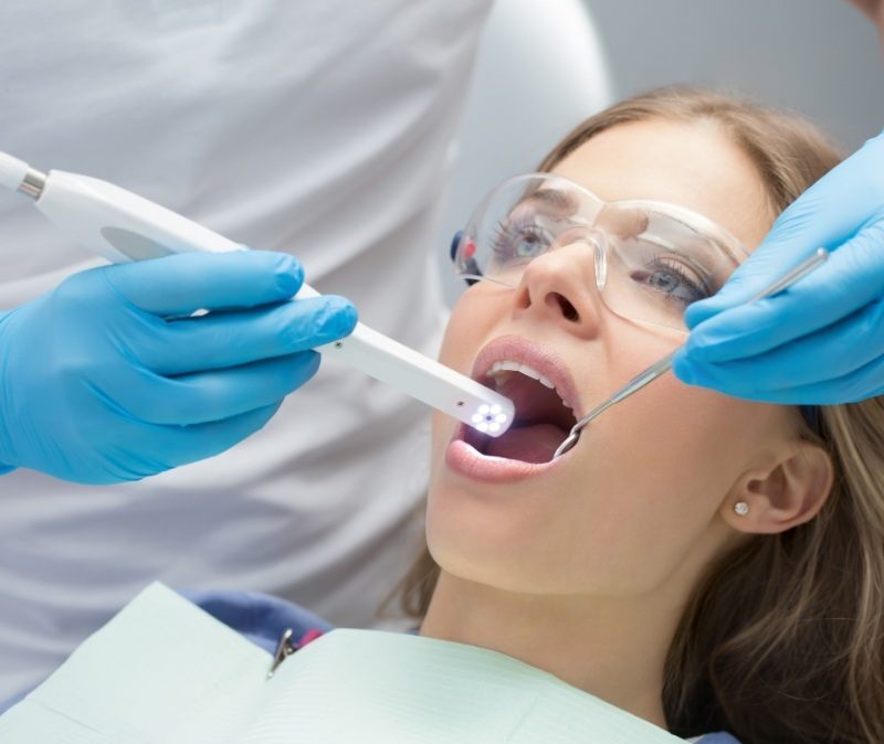 Dentist using intraoral camera to capture smile images