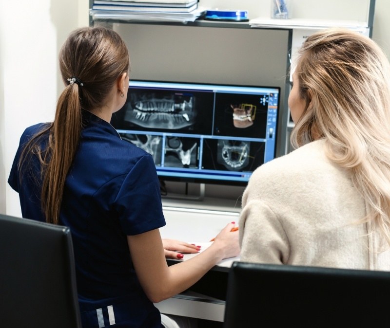 Dental team member looking at digital x rays