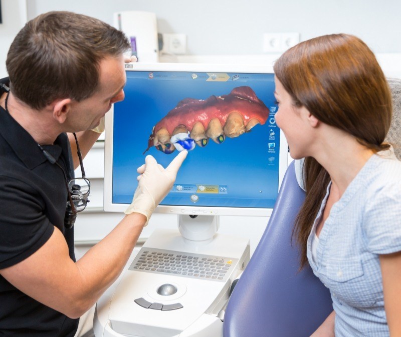 Dentist explaining the benefits of CEREC dental restorations