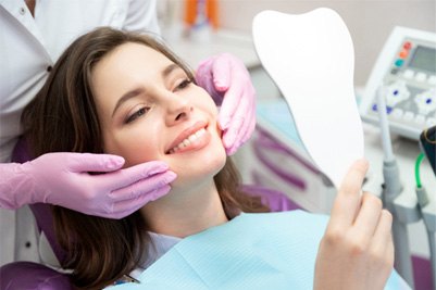 woman smiling while getting cosmetic dentistry 