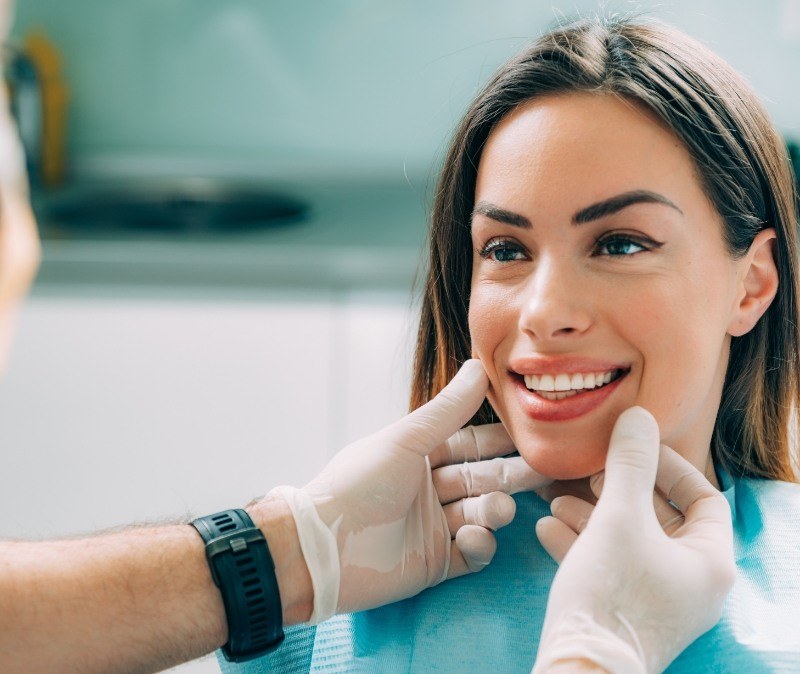 Dentist examining dental patient after smile makeover