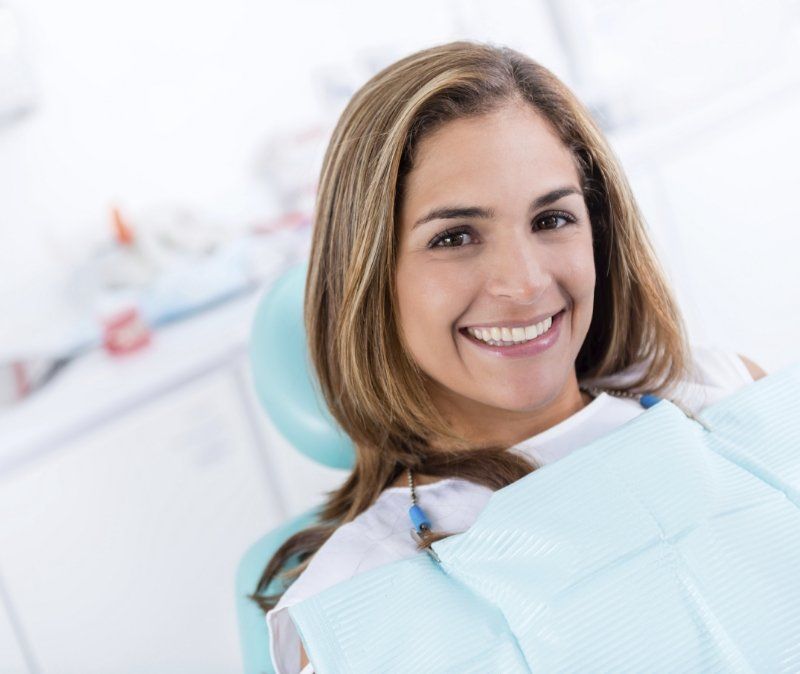 Woman with healthy smile after dental checkup and teeth cleaning
