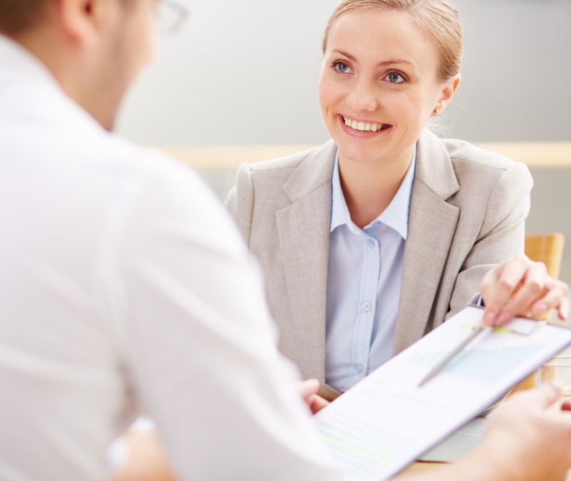 Dentist and dentistry patient discussing dental insurance coverage