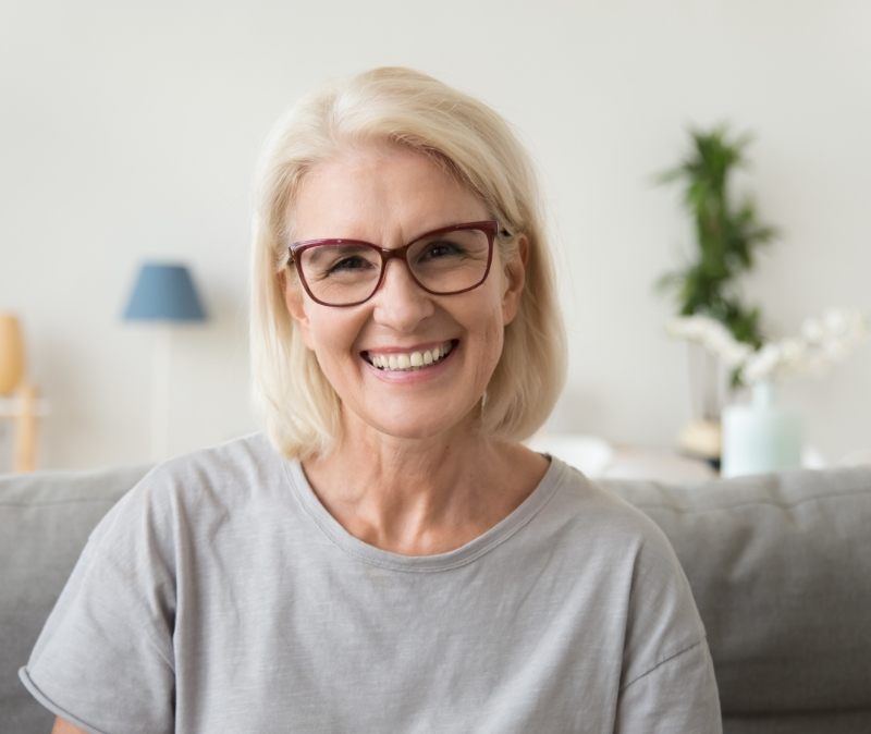 Woman sharing healthy smile after visiting the dentist