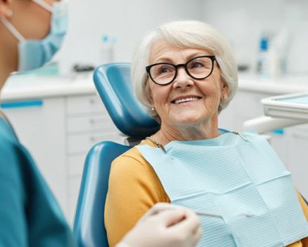 Senior patient talking with dental team member
