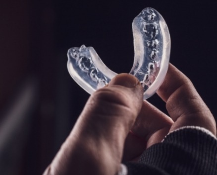 Hand holding a protective mouthguard