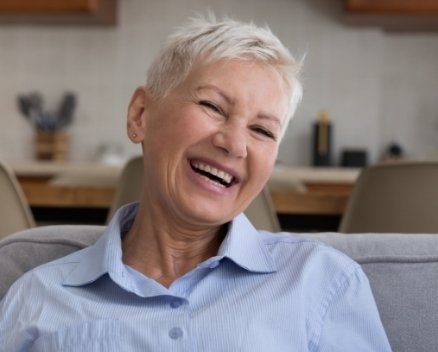 Woman smiling after emergency dentistry