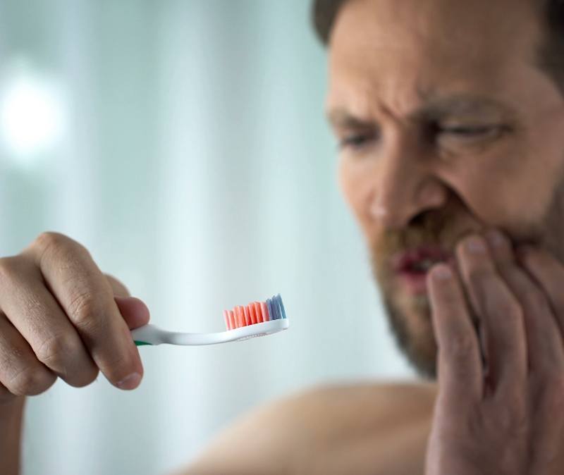 Man in pain before gum disease treatment