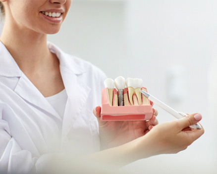 Dental team member talking about dental implants