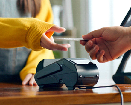 Person using card to pay for services