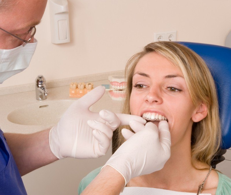 Dentist placing an Invisalign tray