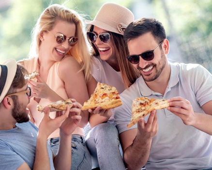 Group of friends enjoying pizza together