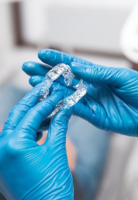Dentist holding Invisalign