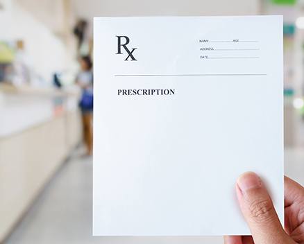 Person holding blank prescription form