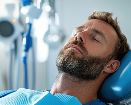 Dental patient relaxing with his eyes closed