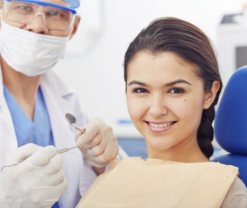 Woman smiling during dental checkup and teeth cleaning visit