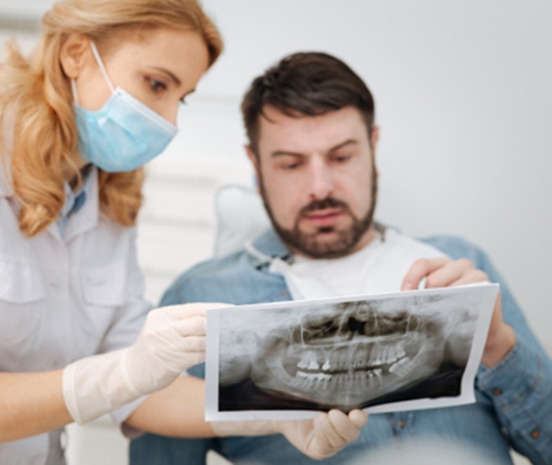 Dentist and patient engaged in serious conversation
