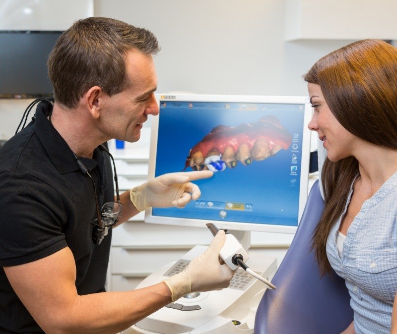 Dentist using CEREC one visit dental restoration system
