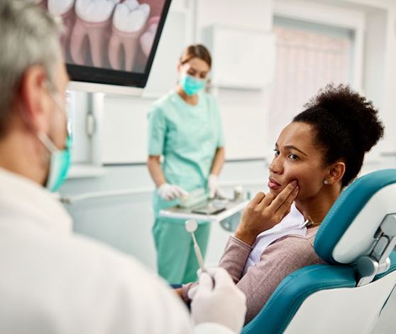 Concerned patient talking to her dentist about her symptoms