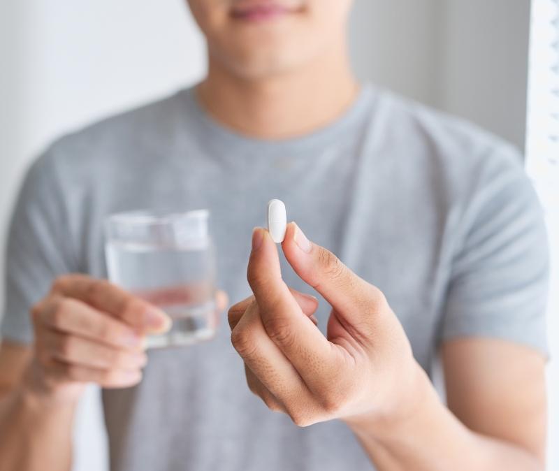 Dental patient taking oral conscious sedation dentistry pill