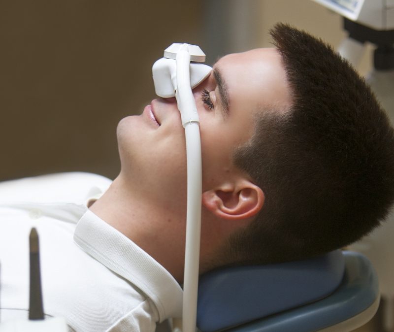 Dentistry patient receiving nitrous oxide dental sedation treatment