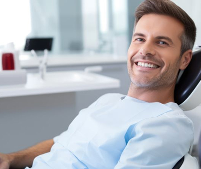 Handsome man in dental treatment chair