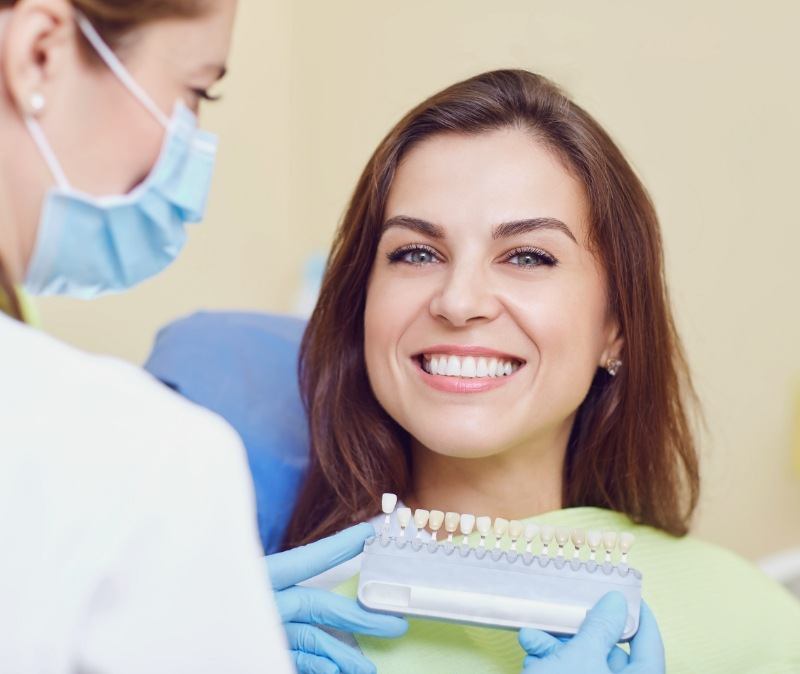 Woman discussing veneers treatment with cosmetic dentist
