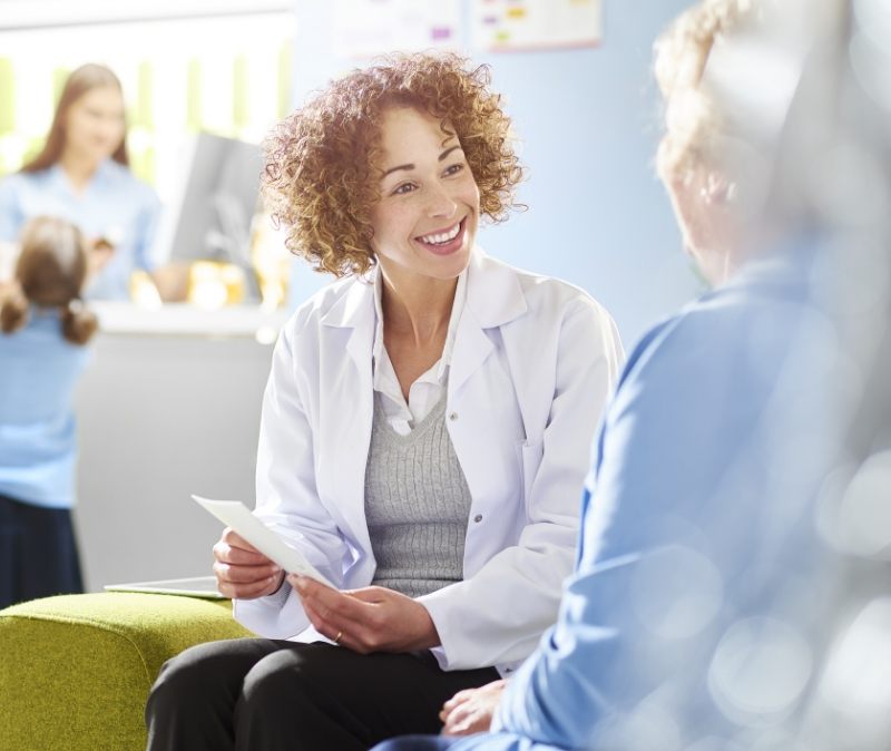 Dentist discussing sleep apnea treatment with dental patient