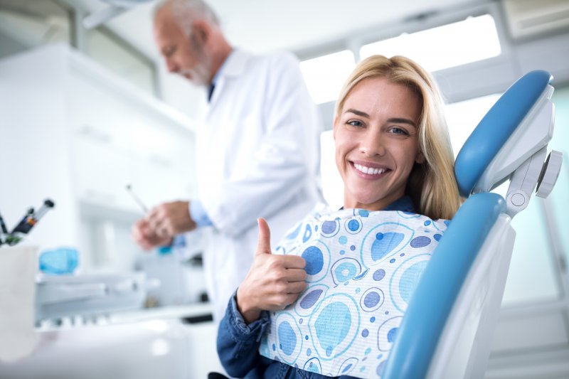 A woman smiling while visiting a dentist in Beachwood.