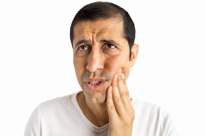 Man considering Invisalign in Beachwood for TMJ pain