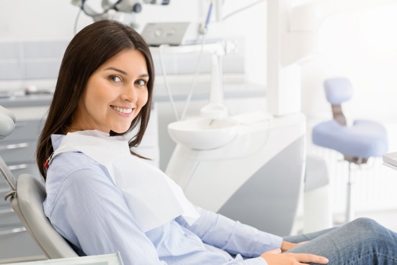 Woman smiling after receiving gum disease therapy