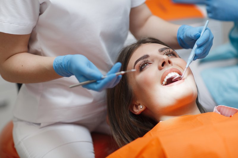 patient smiling while getting dental crown in Beachwood