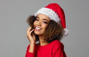 smiling woman wearing santa hat