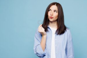 Curious woman holding Invisalign aligner