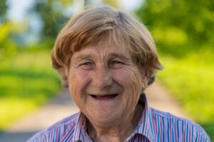 Smiling senior woman with missing teeth